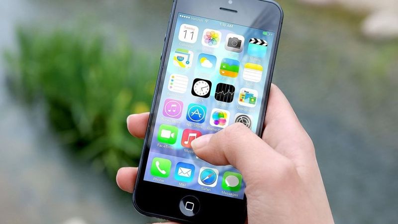 рука со смартфоном, на экране - значки приложений